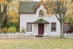 Photo of house with white picket fence